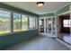 Inviting sunroom with tiled floor, and bright windows at 3503 Casablanca Ave, St Pete Beach, FL 33706