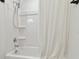 Bright bathroom features a white tub and shower combination with adjustable shower head and chrome fixtures at 4326 Banjo Lake Rd, Land O Lakes, FL 34639