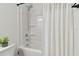 Bright bathroom features shower with tub combination, white walls, and sleek fixtures at 4326 Banjo Lake Rd, Land O Lakes, FL 34639