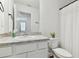 Well-lit bathroom with granite countertop, white cabinets, and shower with tub combination at 4326 Banjo Lake Rd, Land O Lakes, FL 34639