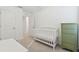 Bright Bedroom space features a crib, carpet flooring, green accent dresser, and ceiling fan at 4326 Banjo Lake Rd, Land O Lakes, FL 34639