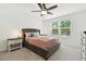 Serene bedroom featuring a gray upholstered bed frame, with a window view of lush greenery at 4326 Banjo Lake Rd, Land O Lakes, FL 34639