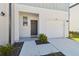 Inviting exterior of a well-maintained townhome featuring a gray door with wreath and attached garage at 4326 Banjo Lake Rd, Land O Lakes, FL 34639