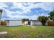 Backyard featuring a small seating area with fencing and a building in the background at 4601 71St N Ave, Pinellas Park, FL 33781