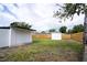 Backyard with a storage shed and fenced perimeter under a cloudy sky at 4601 71St N Ave, Pinellas Park, FL 33781