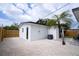 Side view of home's exterior with a small tropical tree surrounded by light-colored gravel at 4601 71St N Ave, Pinellas Park, FL 33781