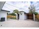 Home's exterior featuring light-colored gravel, a small tropical tree, and fenced perimeter at 4601 71St N Ave, Pinellas Park, FL 33781