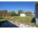 Spacious backyard featuring a storage shed, partially fenced, and mixed grass at 4601 71St N Ave, Pinellas Park, FL 33781