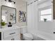 Updated bathroom with stylish vanity, black accents, large mirror, and tiled shower with a window at 4601 71St N Ave, Pinellas Park, FL 33781