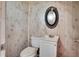 Old-fashioned bathroom with toilet, sink, mirror, and weathered paneling on the walls at 4601 71St N Ave, Pinellas Park, FL 33781