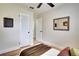 Bright bedroom with ceiling fan, wood floors, and access to an additional room at 4601 71St N Ave, Pinellas Park, FL 33781