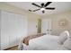Relaxing bedroom with a large closet, ceiling fan, decorative mirror, and ensuite bathroom at 4601 71St N Ave, Pinellas Park, FL 33781