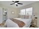 Cozy bedroom with a ceiling fan, decorative mirror, two windows and adjacent bathroom at 4601 71St N Ave, Pinellas Park, FL 33781