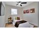 Comfortable bedroom featuring sports themed artwork, ceiling fan, wood floors and a large window at 4601 71St N Ave, Pinellas Park, FL 33781