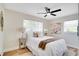 Bright bedroom features neutral decor, a ceiling fan, a large window and hardwood flooring at 4601 71St N Ave, Pinellas Park, FL 33781