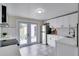 Bright kitchen with stainless steel appliances, white cabinets, subway tile backsplash, and unique flooring at 4601 71St N Ave, Pinellas Park, FL 33781