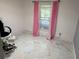 Bedroom with marble floors, pink curtains, and a window offering natural light at 520 Oak Creek Dr, Brandon, FL 33511