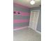Bedroom features a gray and pink striped wall, marble floors, and a closet at 520 Oak Creek Dr, Brandon, FL 33511
