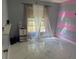 Bedroom with eye-catching striped accent wall, modern marble flooring, and natural light at 520 Oak Creek Dr, Brandon, FL 33511