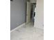 Bedroom with marble flooring, neutral walls, and a doorway to another room at 520 Oak Creek Dr, Brandon, FL 33511