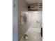 A gray and white hallway displays unique lighting, decorative wall art, and tiled flooring at 520 Oak Creek Dr, Brandon, FL 33511