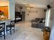 Open-concept living room showcasing a stylish wood feature wall, tile floors and kitchen access at 520 Oak Creek Dr, Brandon, FL 33511