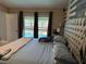 Main bedroom view showcasing accent wall, plush headboard, and pool view from the window at 520 Oak Creek Dr, Brandon, FL 33511