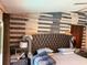 Main bedroom boasts a decorative accent wall, plush headboard, and natural light at 520 Oak Creek Dr, Brandon, FL 33511