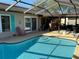 Outdoor pool area featuring a covered bar and lounge for entertaining guests by the pool at 520 Oak Creek Dr, Brandon, FL 33511