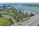 Aerial view of waterfront condo community near beach, golf, and ocean access; red arrow shows unit location at 5701 Bahia Del Mar Cir # 408, St Petersburg, FL 33715