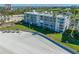 Aerial view of a beachfront condo, with a manicured lawn and beach at 5701 Bahia Del Mar Cir # 408, St Petersburg, FL 33715