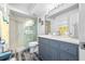 Bright bathroom features a glass-enclosed shower, wood-look flooring, and a vanity with plenty of storage at 5701 Bahia Del Mar Cir # 408, St Petersburg, FL 33715