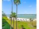 Beautiful view of the white sand beach with tiki hut umbrellas and calm water at 5701 Bahia Del Mar Cir # 408, St Petersburg, FL 33715