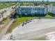 Exterior view of condo with beach access, Tiki Hut umbrellas, and Gulf views, perfect for relaxation at 5701 Bahia Del Mar Cir # 408, St Petersburg, FL 33715