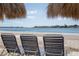 Three beach chairs sitting on white sand, with views of the ocean at 5701 Bahia Del Mar Cir # 408, St Petersburg, FL 33715