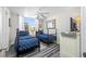 Inviting bedroom featuring twin beds with nautical-themed bedding, natural light, and stylish decor for a cozy retreat at 5701 Bahia Del Mar Cir # 408, St Petersburg, FL 33715