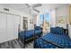 Comfortable bedroom featuring twin beds with anchor bedding and a view to the bath, creating a relaxing and inviting space at 5701 Bahia Del Mar Cir # 408, St Petersburg, FL 33715