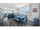 Bright dining room featuring a blue table set and views of the water at 5701 Bahia Del Mar Cir # 408, St Petersburg, FL 33715