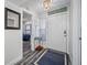 Inviting entryway with wood-look flooring, a 'Relax' sign, and a peek into a bedroom, creating a warm welcome at 5701 Bahia Del Mar Cir # 408, St Petersburg, FL 33715