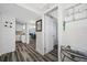 Hallway leading to updated kitchen & dining area, complimented by neutral decor & wood-look floors, for seamless flow at 5701 Bahia Del Mar Cir # 408, St Petersburg, FL 33715
