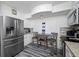 Kitchen with stainless steel appliances, white cabinets, and breakfast nook at 5701 Bahia Del Mar Cir # 408, St Petersburg, FL 33715