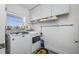 Bright laundry room with a washer and dryer, storage cabinets and a view from the window at 5701 Bahia Del Mar Cir # 408, St Petersburg, FL 33715
