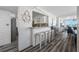 Open living space with bar seating, nautical decor, and water views from the windows at 5701 Bahia Del Mar Cir # 408, St Petersburg, FL 33715