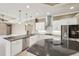 Well-lit modern kitchen with white cabinets, stainless steel appliances, and dark countertops at 6130 Kestrelridge Dr, Lithia, FL 33547