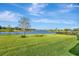 Expansive backyard featuring green grass and water views at 6324 Brevada Ln, Apollo Beach, FL 33572