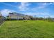 Expansive lush green backyard featuring a pond and the back of the home at 6324 Brevada Ln, Apollo Beach, FL 33572