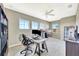 Carpeted bedroom with ceiling fan, natural light from three large windows, and two desks set up at 6324 Brevada Ln, Apollo Beach, FL 33572