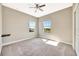 Bright bedroom with neutral paint, carpet, baseboards, a ceiling fan, and natural light from two windows at 6324 Brevada Ln, Apollo Beach, FL 33572