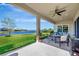 Covered patio featuring a ceiling fan and views of pond and backyard at 6324 Brevada Ln, Apollo Beach, FL 33572