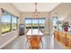 Dining room with a traditional table and chairs set, lots of natural light, and view of backyard at 6324 Brevada Ln, Apollo Beach, FL 33572